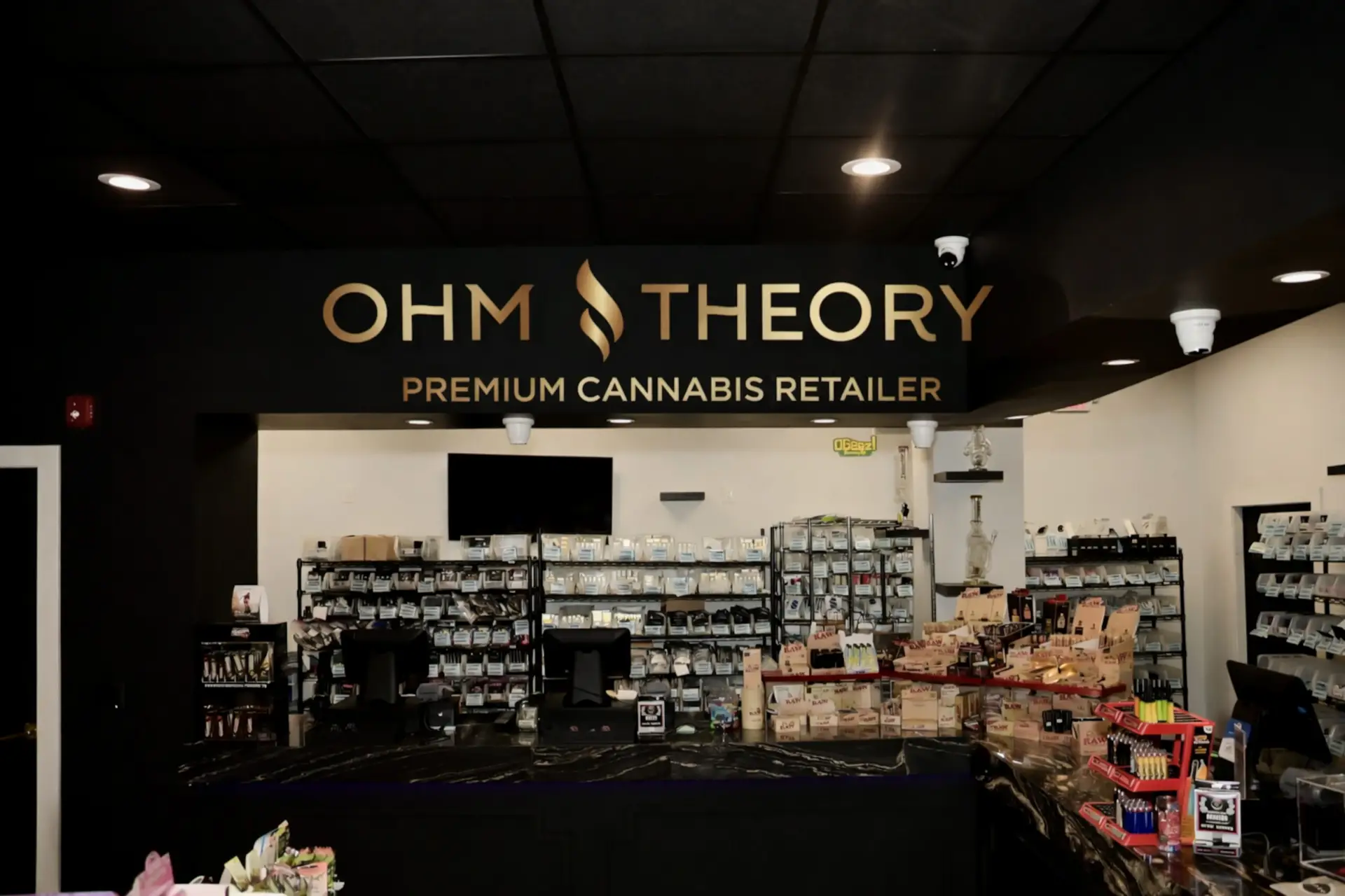 Ohm Theory premium cannabis retail interior in Elmwood Park NJ near Paramus and Hackensack with product shelves and branding