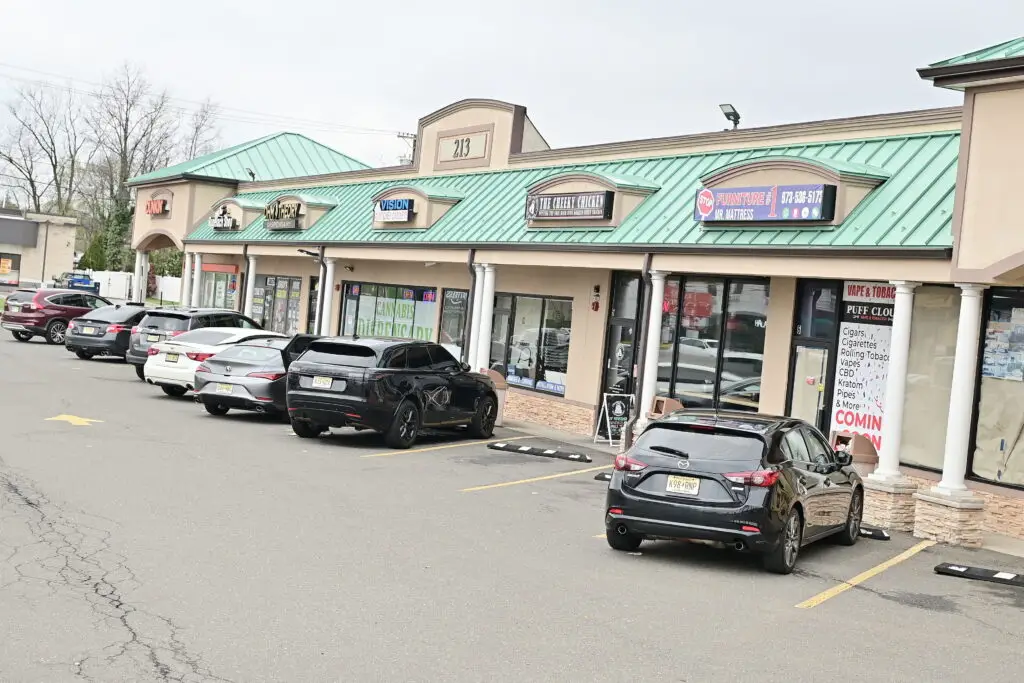 Ohm Theory cannabis dispensary parking lot in Elmwood Park NJ near Clifton and Fair Lawn with storefront view best time to visit MetLife Stadium