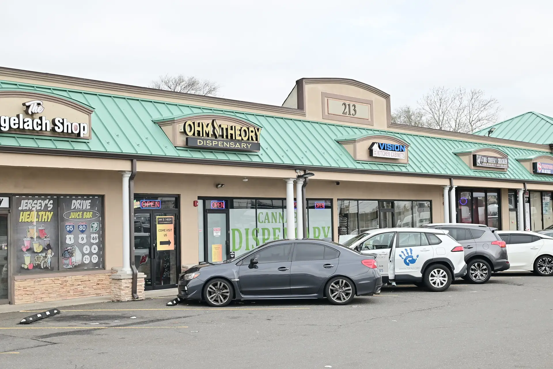 Ohm Theory cannabis dispensary storefront in Elmwood Park NJ near Fair Lawn and Saddle Brook with parking and retail plaza view