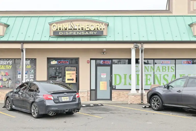 entrance of Ohm Theory cannabis dispensary in Elmwood Park NJ near Garfield and Fair Lawn with open signs and storefront