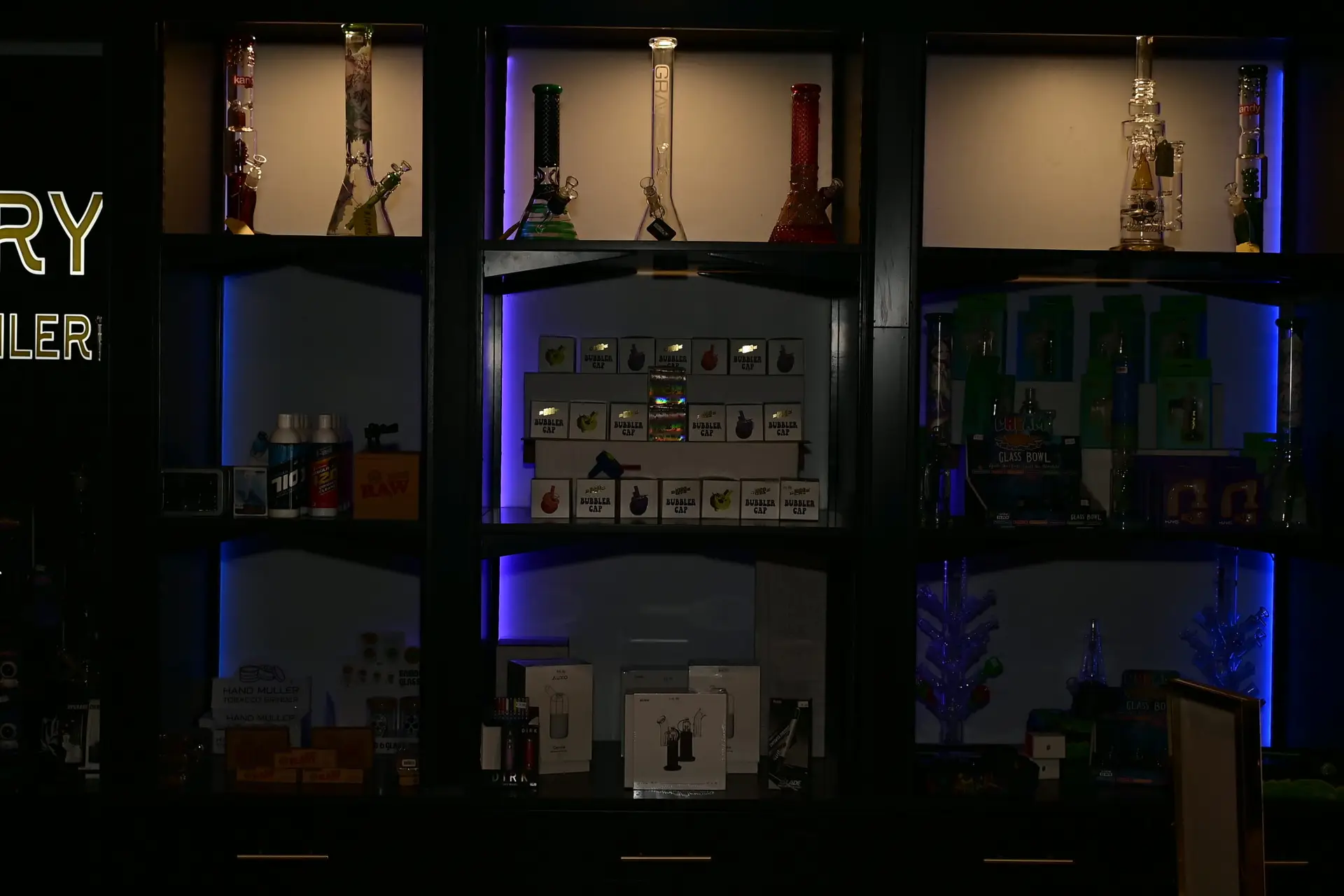 blue LED cannabis accessories display with glass pieces at Ohm Theory dispensary in Elmwood Park NJ near Passaic and Clifton