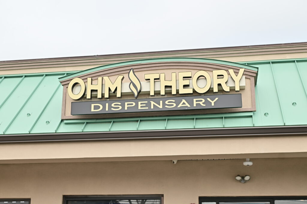 Ohm Theory cannabis dispensary storefront sign in Elmwood Park NJ near Paterson. things to do near MetLife Stadium