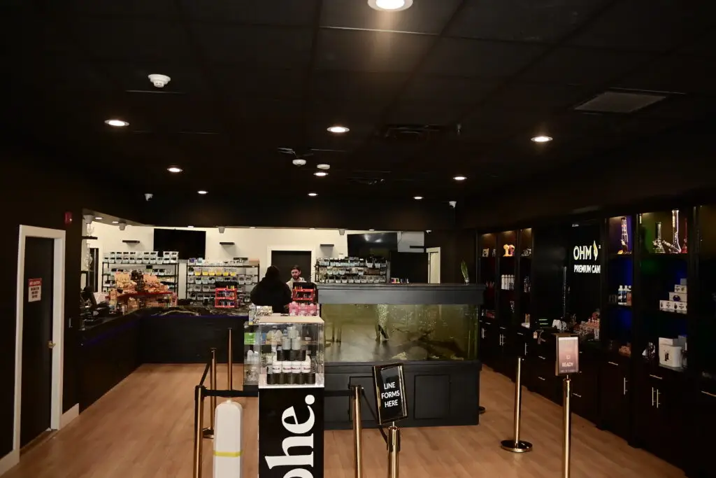 Interior of Ohm Theory cannabis dispensary in Elmwood Park NJ near Paramus and Hackensack showing checkout counter and product displays what to do before and after a game at MetLife Stadium